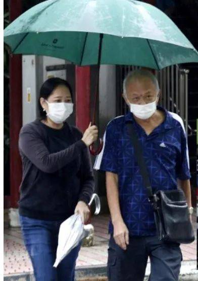 为您点个赞，牛车水女子下雨天为路人撑伞过马路